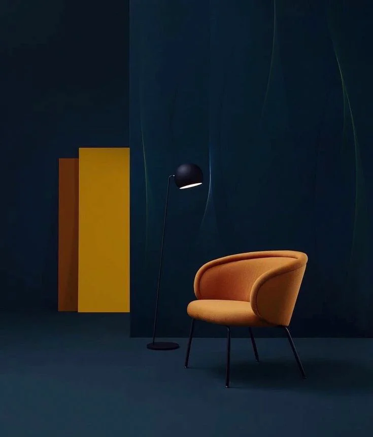 painting services Abu Dhabi | Navy blue painted wall with orange chair in it